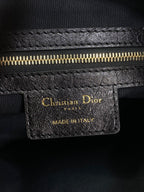Black leather Dior tag with gold lettering and 'MADE IN ITALY' stamp