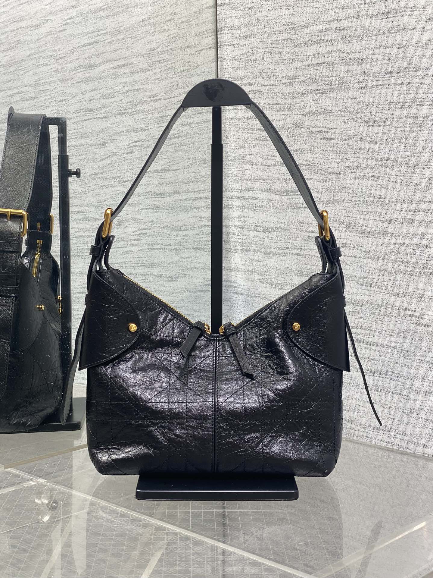 Dior black leather shoulder hobo bag with flap pocket and dangling strap