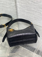 Black leather small hobo bag with gold emblem clasp and curved top handles