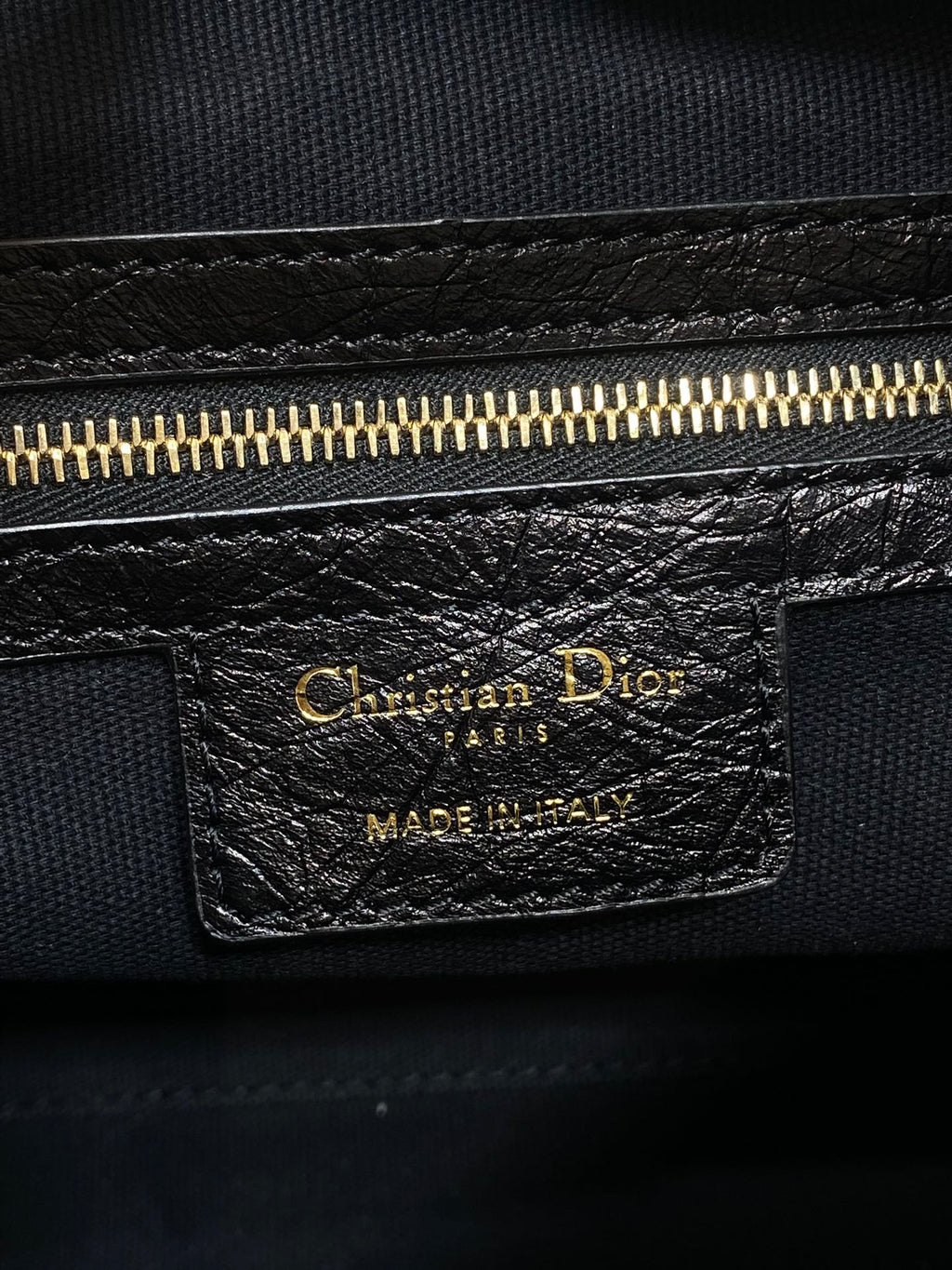Christian Dior Paris leather label with gold zipper and Made in Italy text