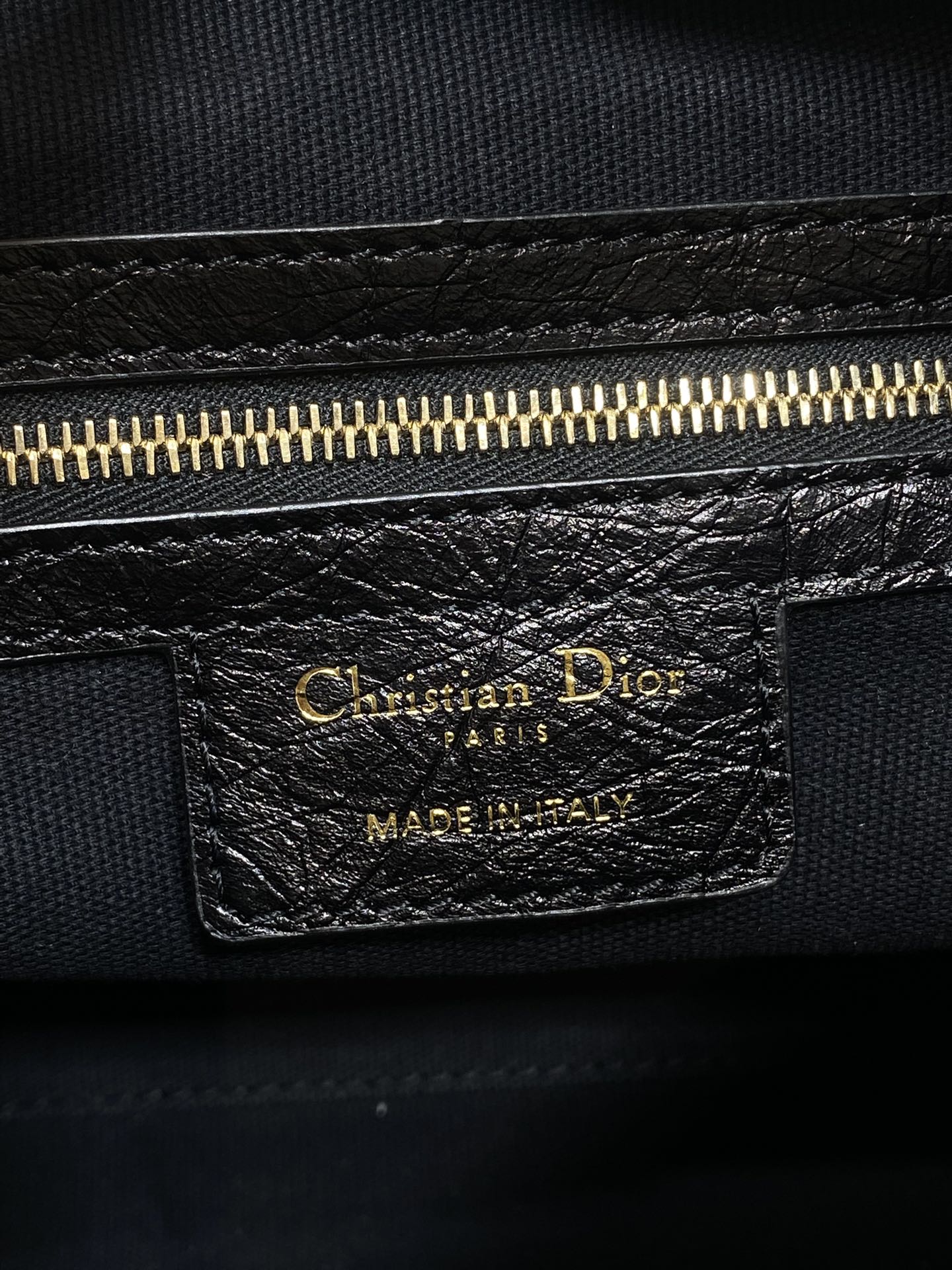 Christian Dior Paris leather label with gold zipper and Made in Italy text