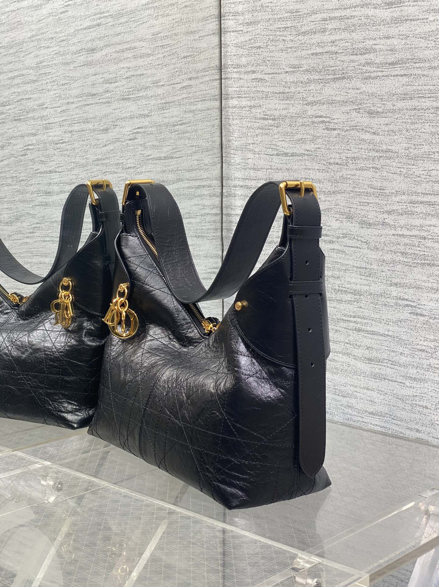 Set of black leather hobo bags with gold-tone hardware, shown side by side