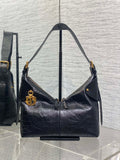 Black leather hobo bag with top handles and gold-tone hardware, front flap detail