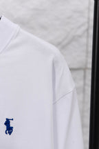 White long-sleeve T-shirt side view with small blue rider logo