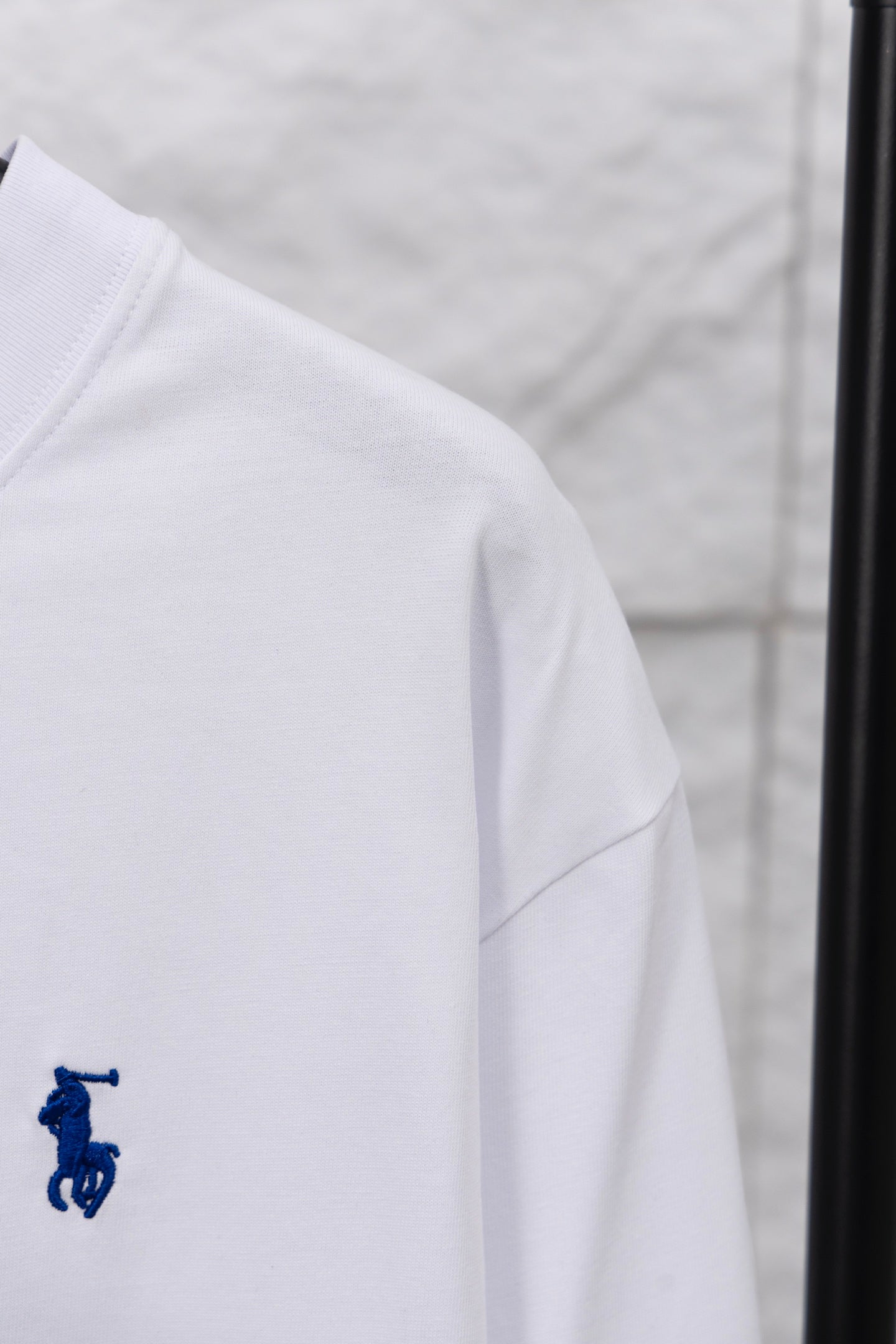 White long-sleeve T-shirt side view with small blue rider logo