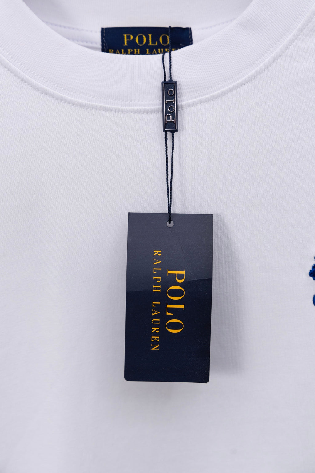 POLO Ralph Lauren neck tag on white T-shirt with blue polo logo