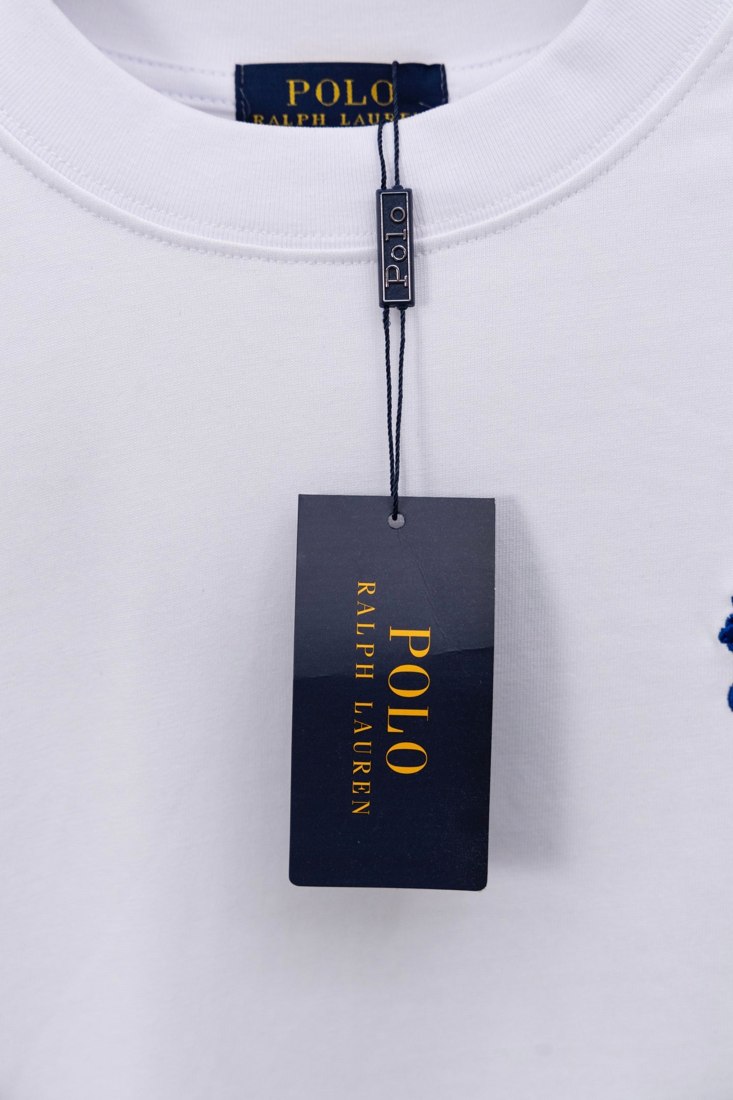 POLO Ralph Lauren neck tag on white T-shirt with blue polo logo
