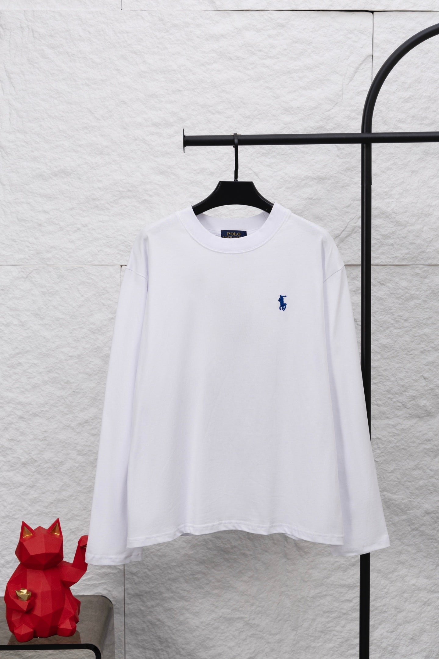 White long-sleeve T-shirt with small blue rider logo on chest