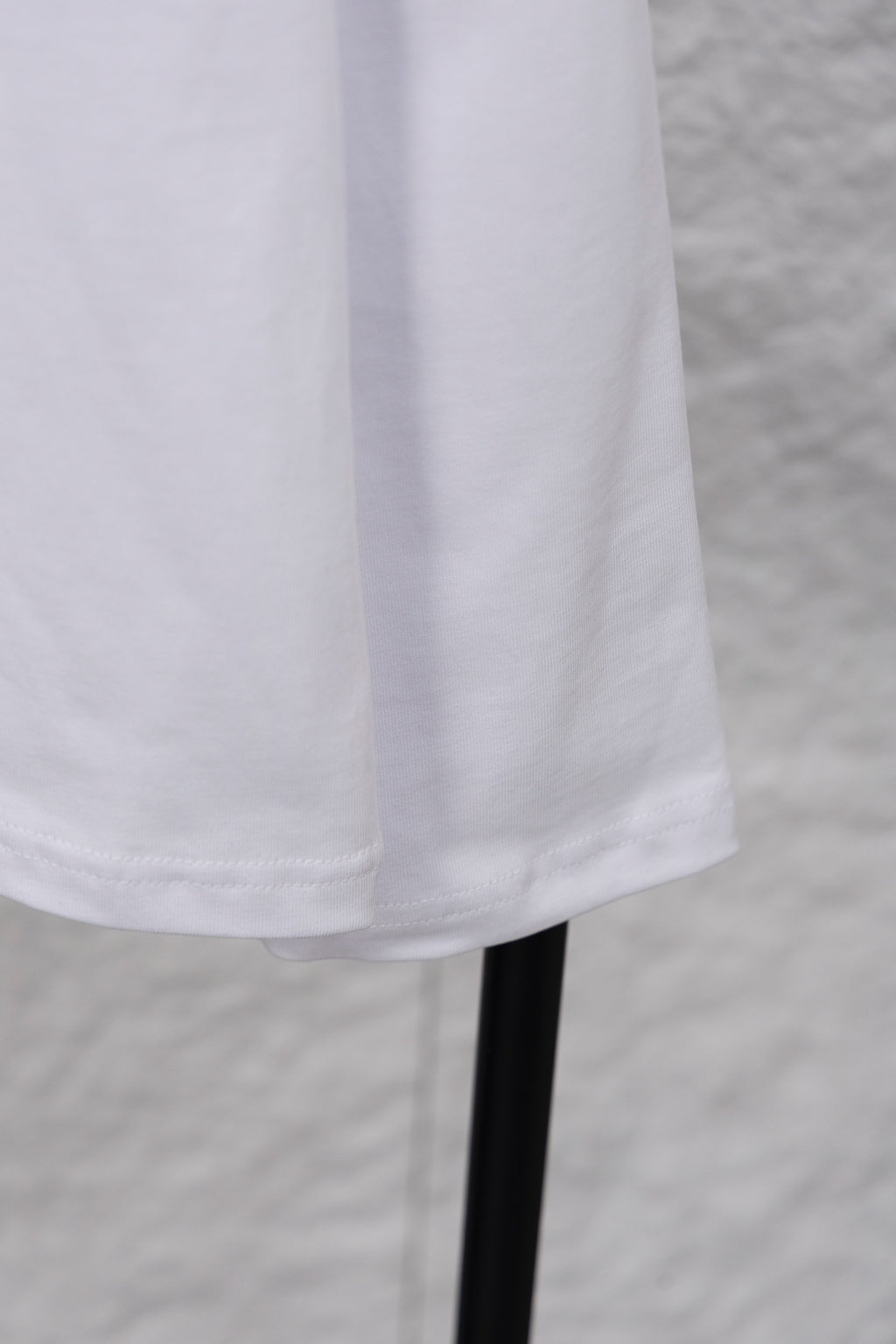White long-sleeve T-shirt hem and sleeve on hanger