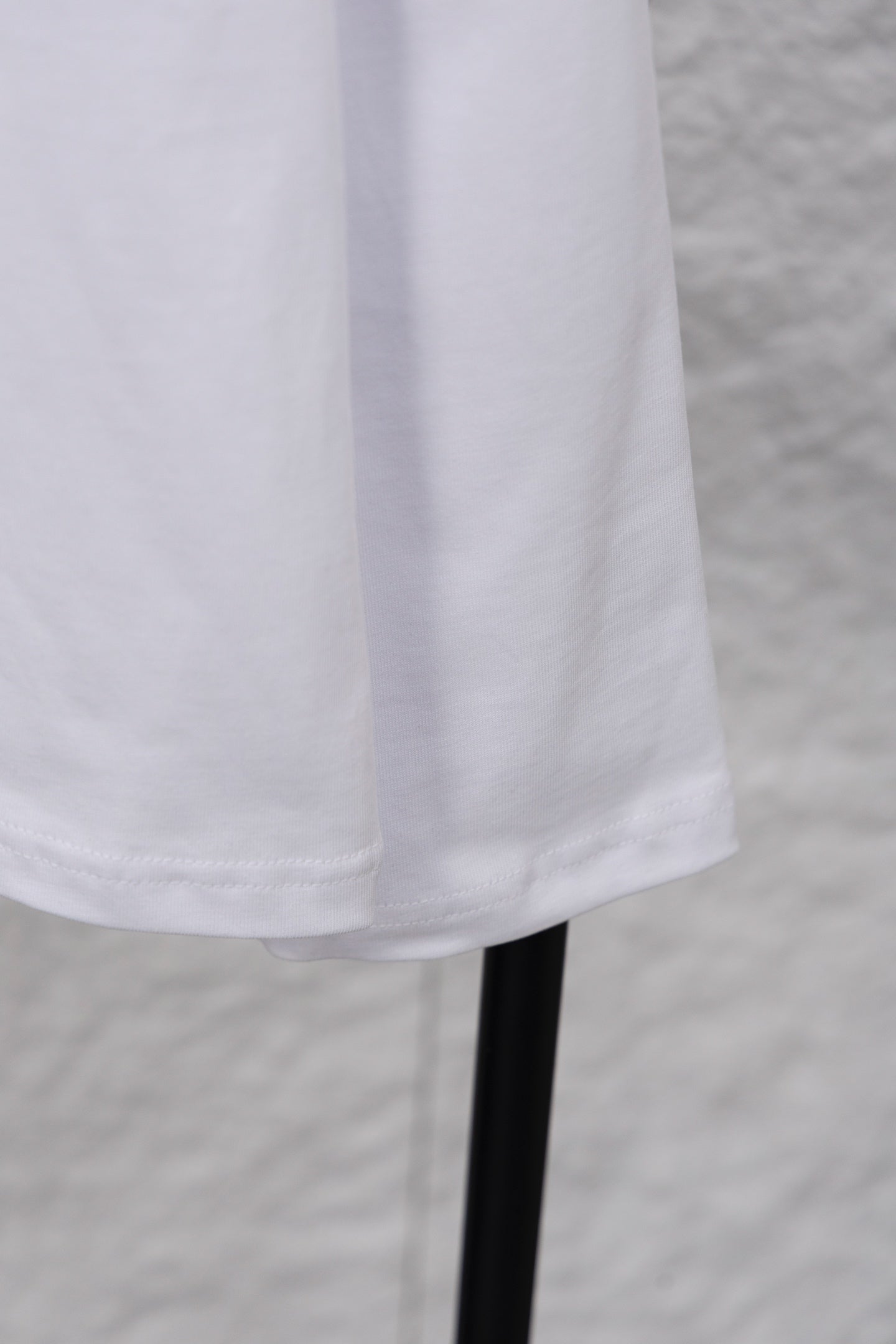 White long-sleeve T-shirt hem and sleeve on hanger