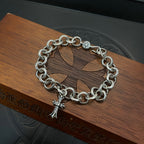 Silver-tone chain bracelet with round links and cross pendant charm