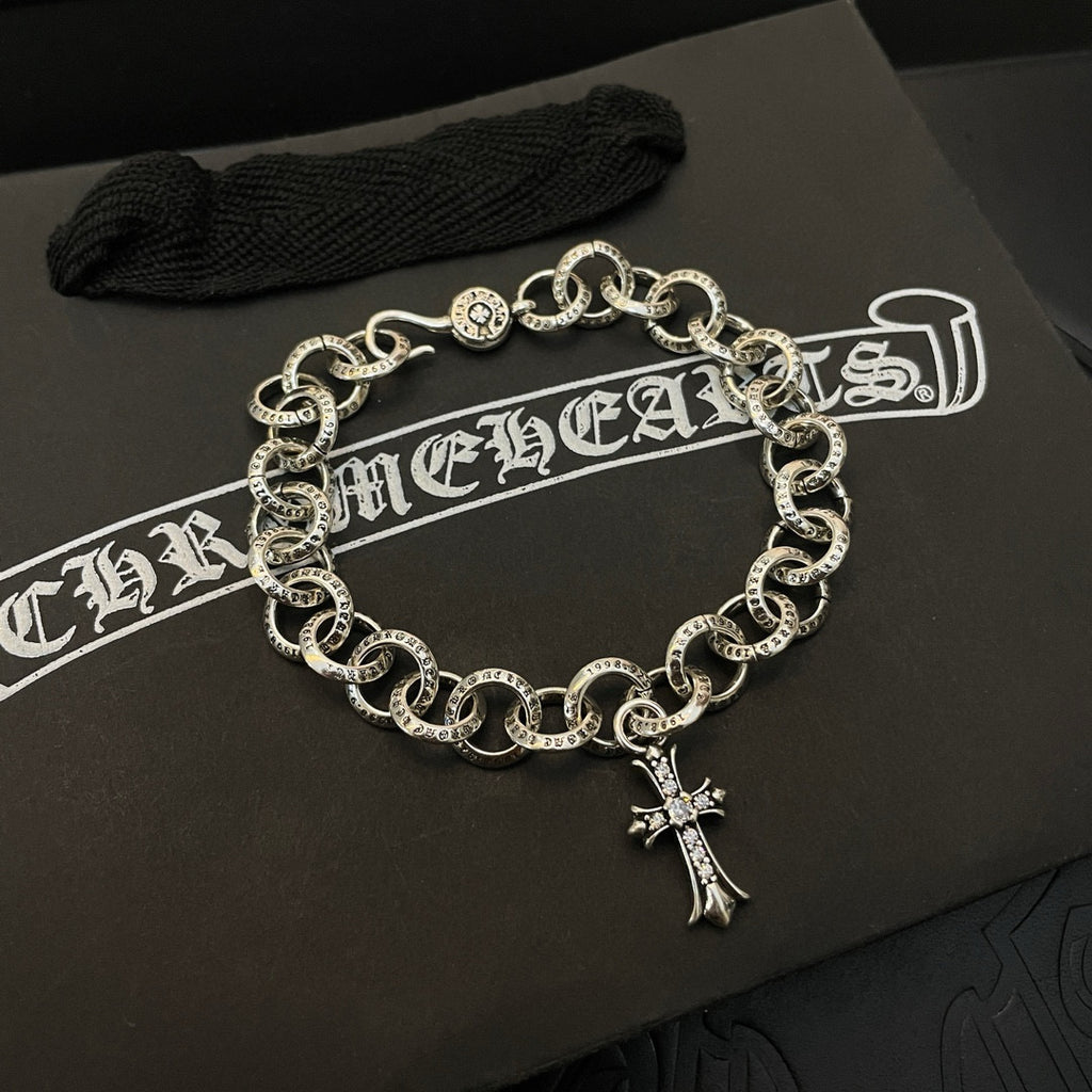 Silver-tone chain bracelet with round links and hanging cross charm