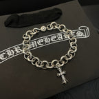 Silver-tone chain bracelet with round links and hanging cross charm