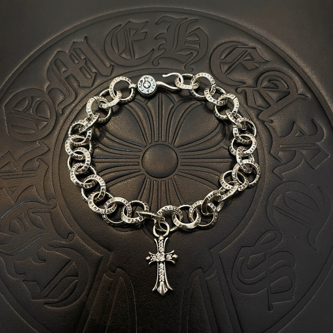 Silver-tone chain bracelet with circular links and cross pendant charm