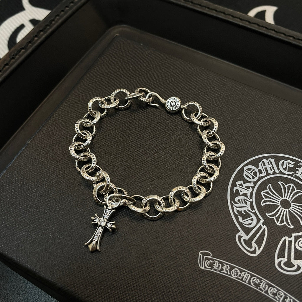 Silver-tone chain bracelet with circular links and hanging cross charm