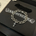 Silver-tone round-link chain bracelet with small cross charm at center