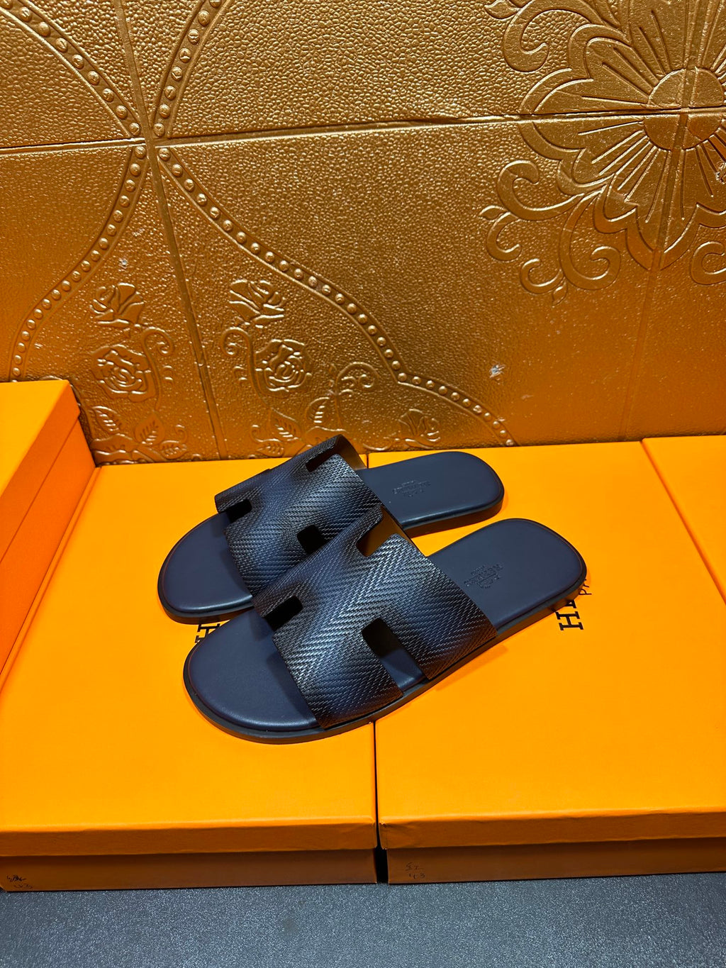 Dark blue textured slide sandals with open toe, H-shaped strap cutouts