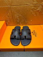Dark blue textured leather slide sandals with open toe and cutout H straps