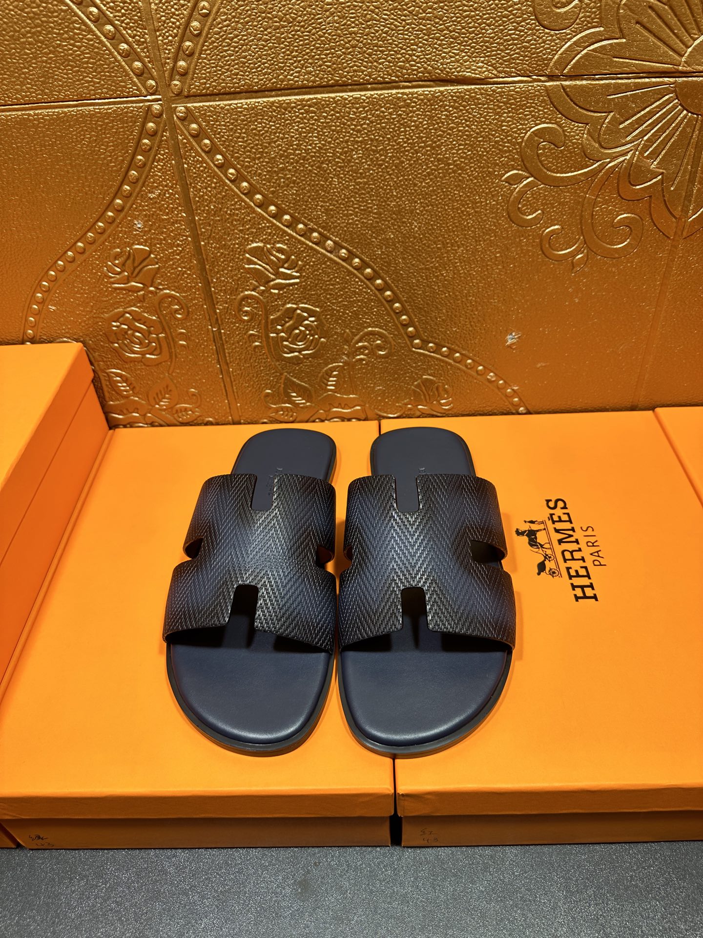 Dark blue textured leather slide sandals with open toe and cutout H straps