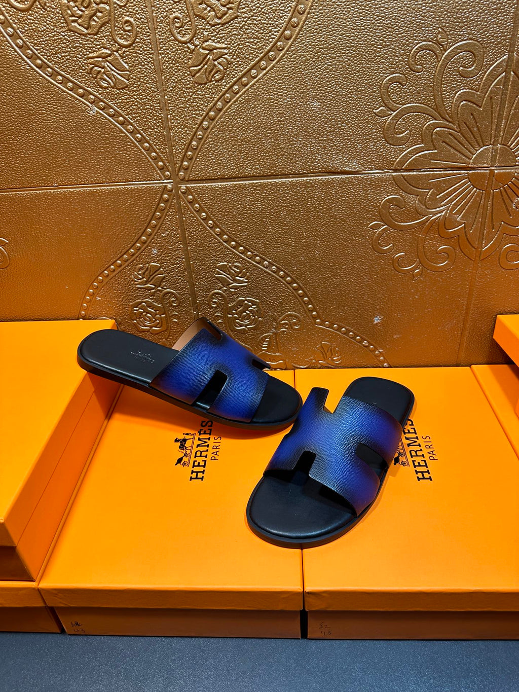 Blue leather slide sandals with square heel tab and black flat sole