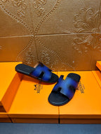 Blue leather slide sandals with square heel tab and black flat sole