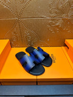 Blue leather slide sandals with four cutout openings and black slip-on sole