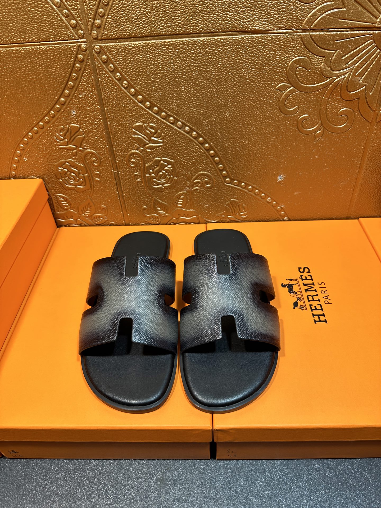 Leather slide sandals with wide adjustable straps and HERMES logo, dark blue.