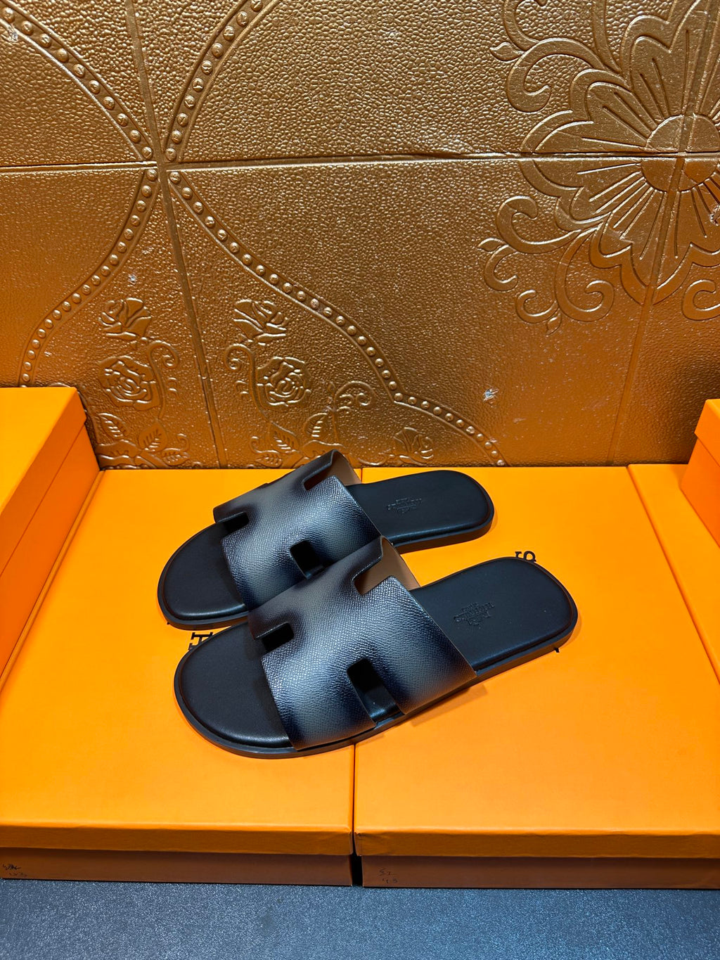 Dark blue leather slide sandals with wide crisscross straps and open toe.