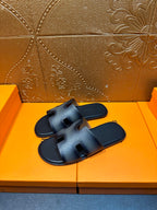 Dark blue leather slide sandals with wide crisscross straps and open toe.
