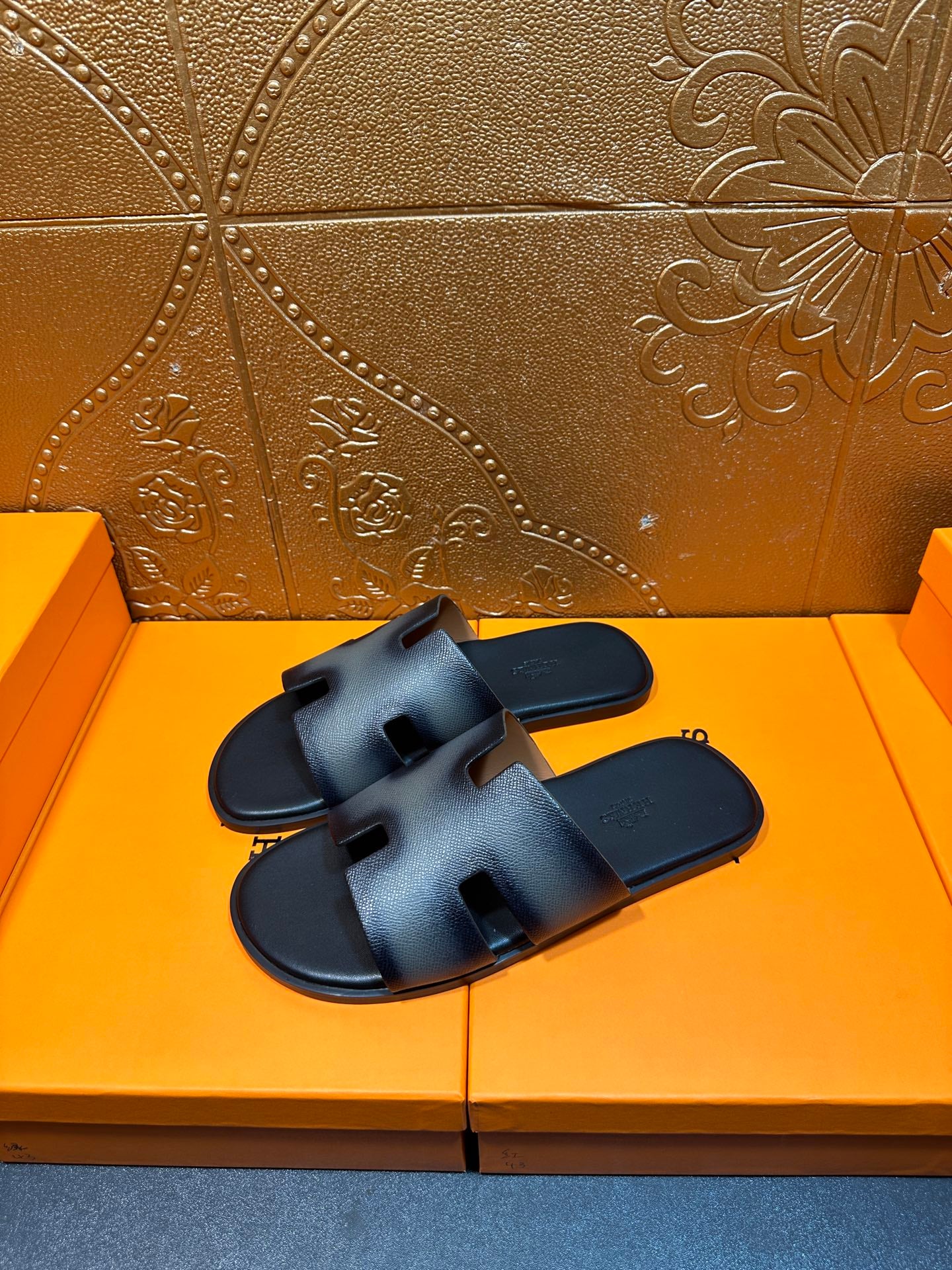 Dark blue leather slide sandals with wide crisscross straps and open toe.