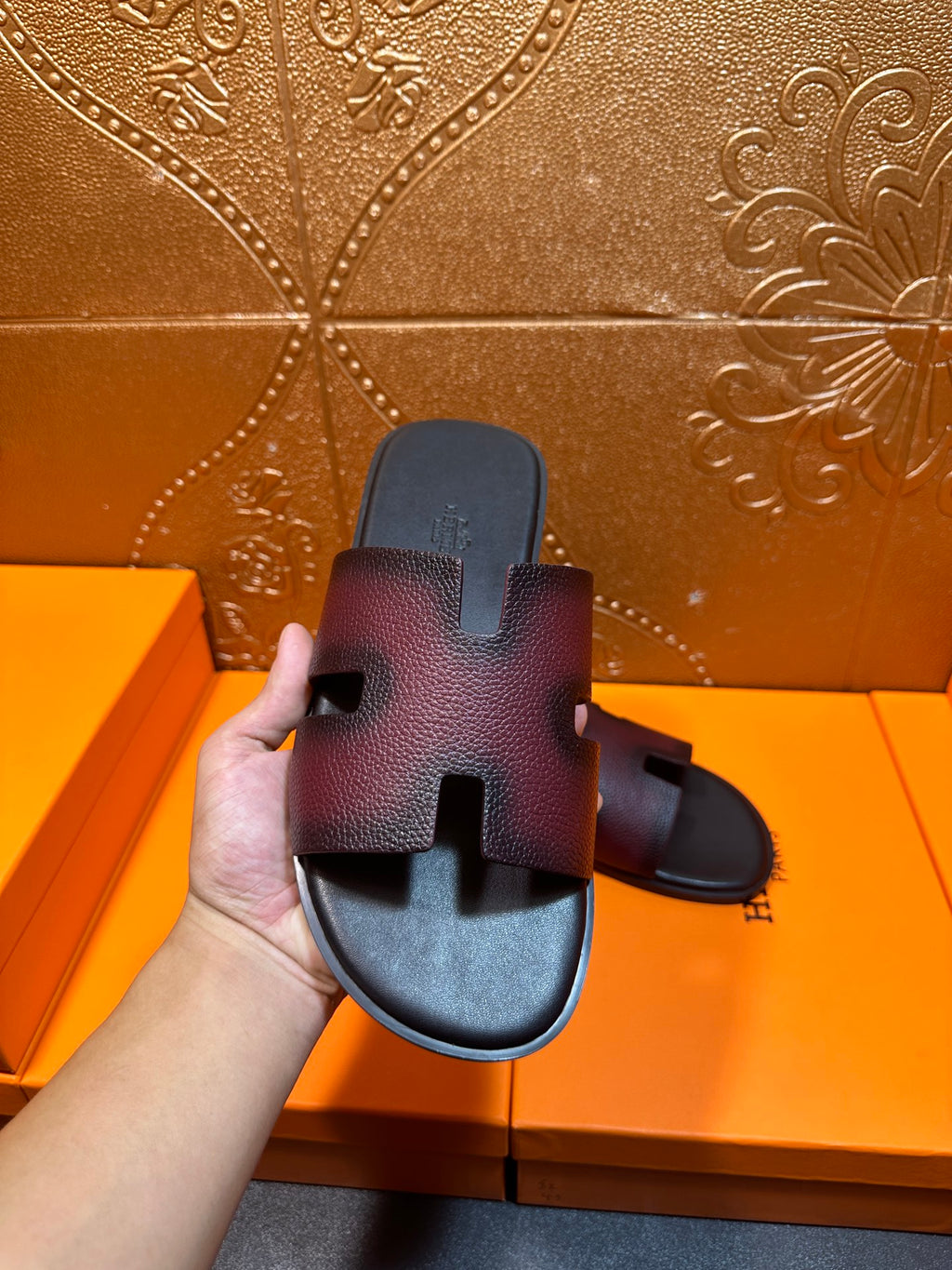 Hermes slide sandals on box lid, H cutout straps, dark textured finish