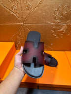 Hermes slide sandals on box lid, H cutout straps, dark textured finish