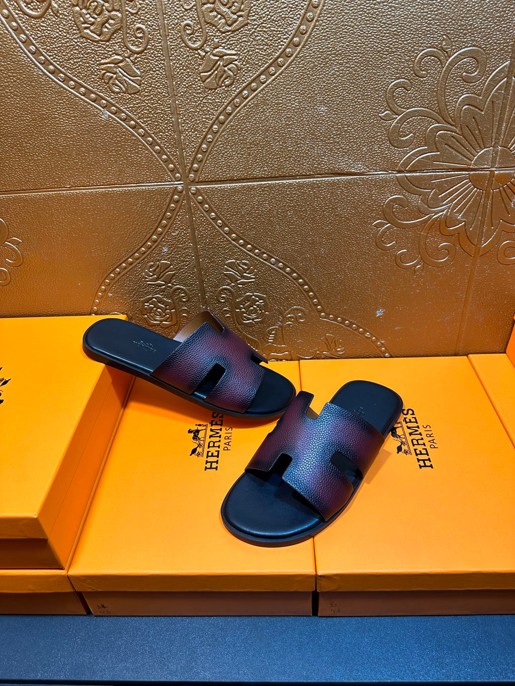 Hermes slide sandals, top view, H cutout straps on dark textured leather