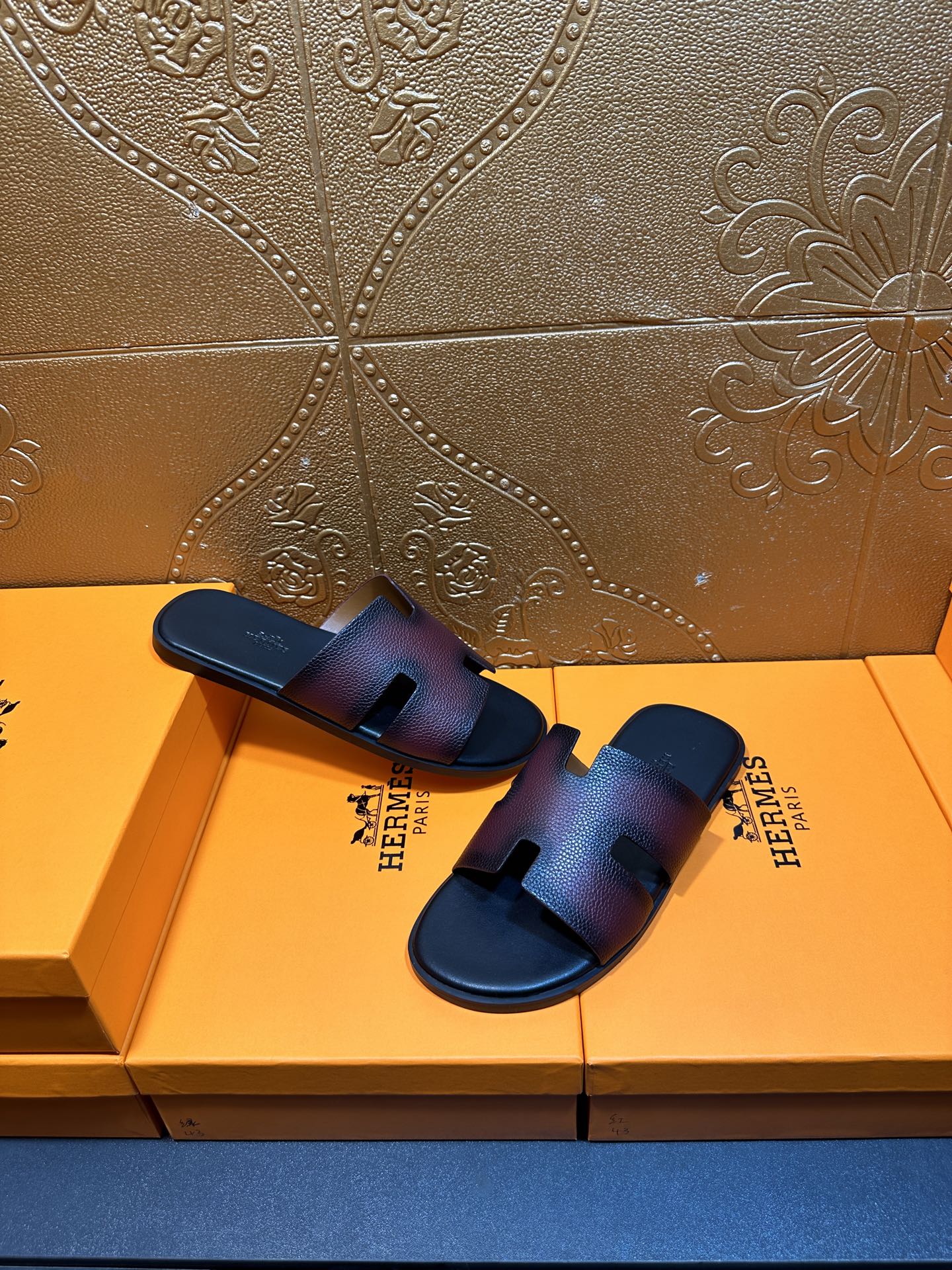 Hermes slide sandals, top view, H cutout straps on dark textured leather