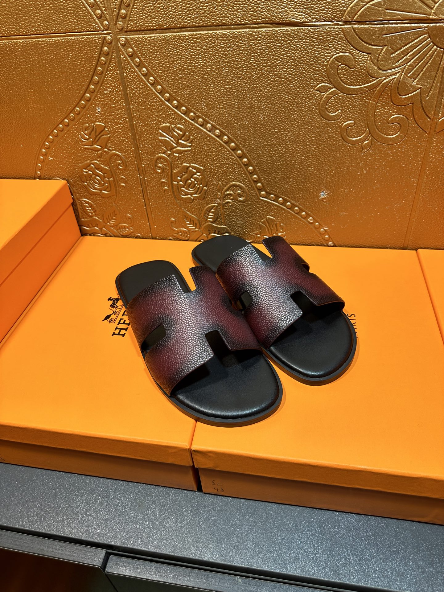 Hermes slide sandals, angled pair view, H cutout straps on dark textured leather