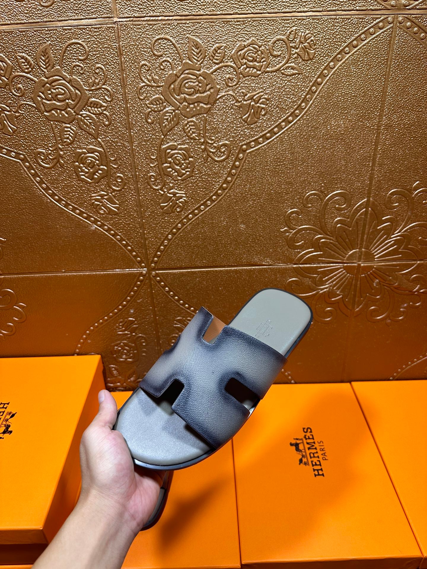 Hermes slide sandals held up, light blue leather with open toe and front cutout
