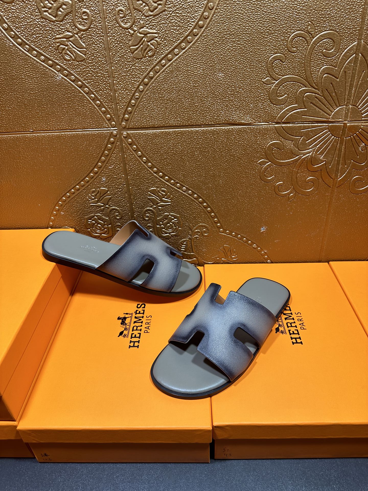 Hermes slide sandals shown from above, light blue leather with front cutout