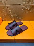 Slide sandals with two wide straps and an H-shaped buckle detail, dark purple