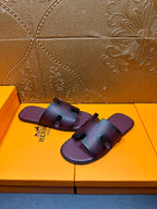 Slide sandals with H buckle strap across the top, dark purple leather