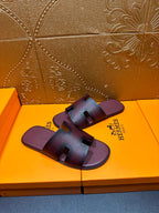 Slide sandals with two-panel straps and dark purple footbed, H buckle detail