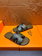 Hermes sandals with blue-green gradient straps, front view on shoebox