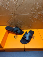 Hermes sandals laid side by side, dark teal leather straps with open toe