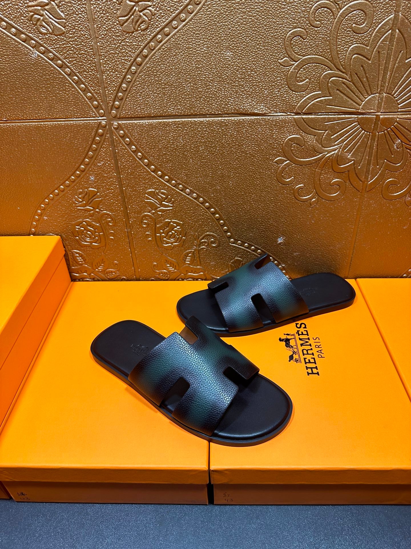 Hermes sandals side view with dark teal straps and open-toe slide design