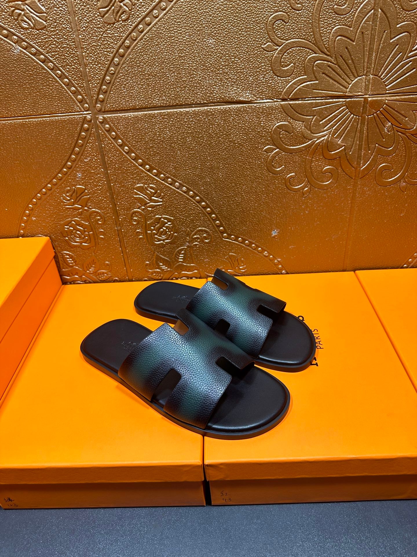 Hermes slide sandals with dark teal leather straps, open toe, and black footbed