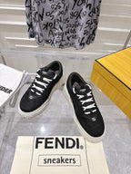 Black Fendi unisex sneakers with white laces, front view of pair on display