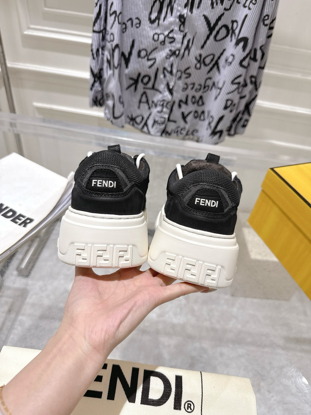 Black Fendi unisex sneakers with white laces, back view showing heel logo
