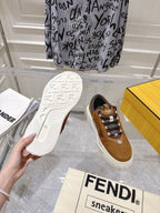 Fendi unisex sneakers with tan upper, dark laces and white sole; tread sole view