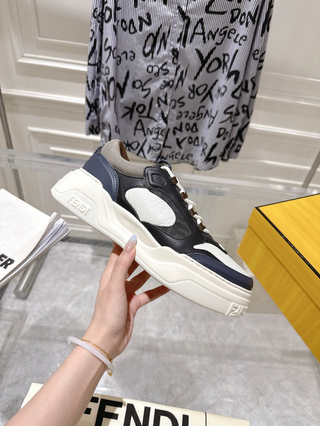 Fendi unisex sneakers side view in black and white with lace-up and navy trim
