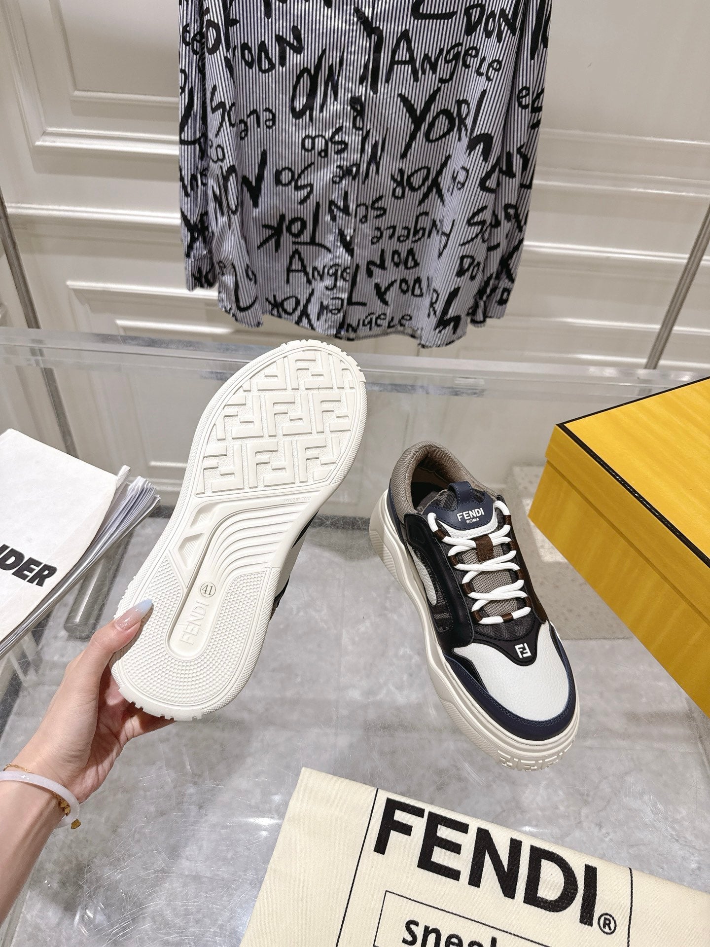 Fendi unisex sneakers outsole and side view, rubber tread with black and white upper