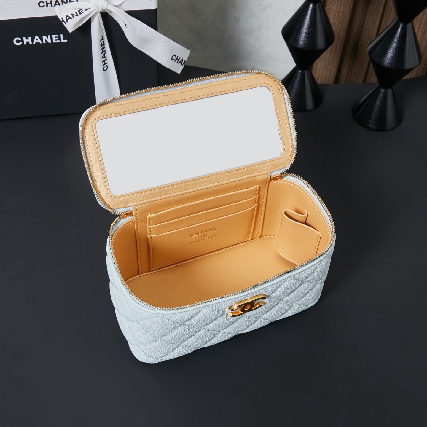 Chanel quilted mini bag with flap open, light blue exterior and tan interior.